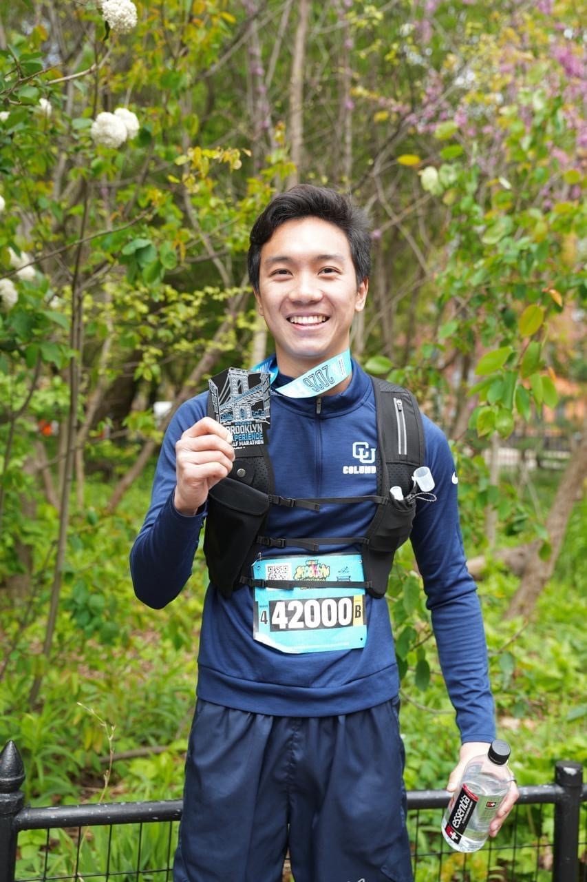 Holding the half marathon finisher medal at the race